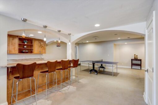 Ridgeview lower-level bar with stools and game room