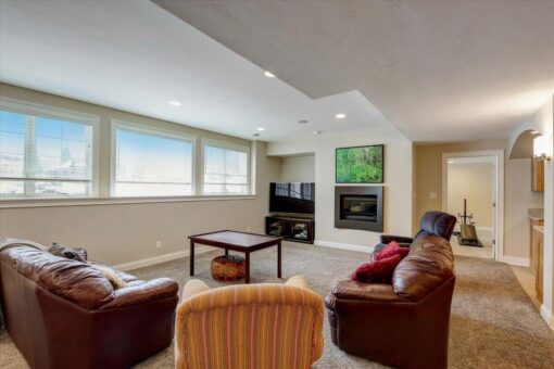 Ridgeview lower-level family room with fireplace and windows