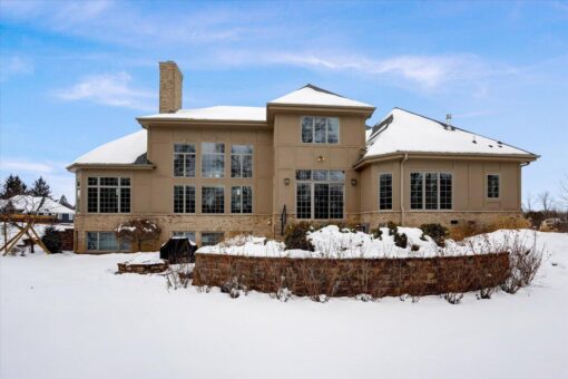 Ridgeview rear elevation with stone exterior in winter