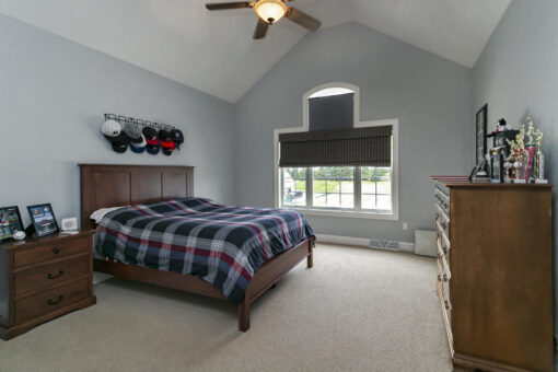 Bradon bedroom with vaulted ceiling and window