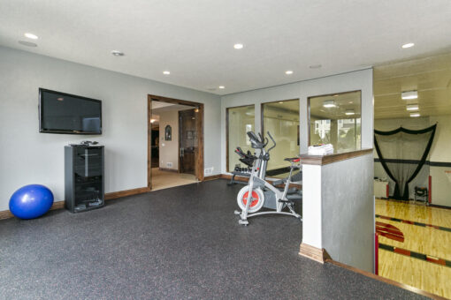Bradon lower-level exercise area with walk-out windows
