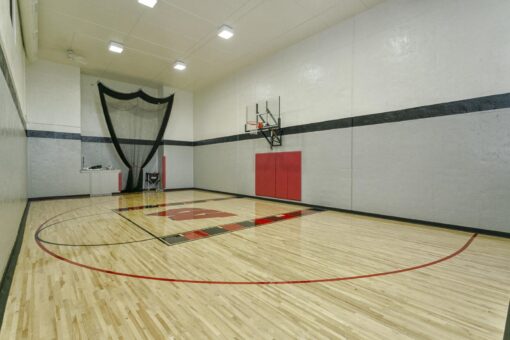 Bradon indoor basketball court with red wall padding