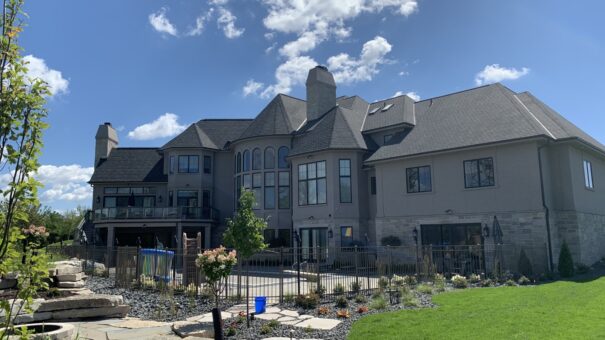 Grand Haven rear elevation with stone exterior and patio
