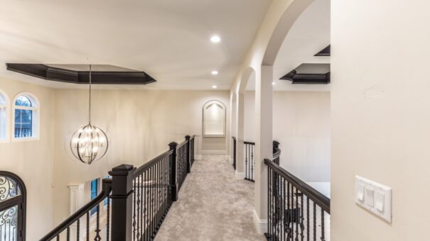 Davidson upper hallway with arched niches and iron railing