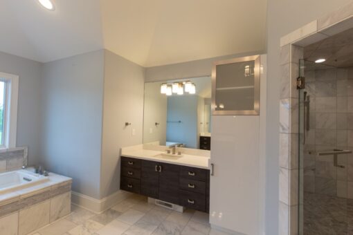 Ravenna primary bath dark vanity and linen cabinet