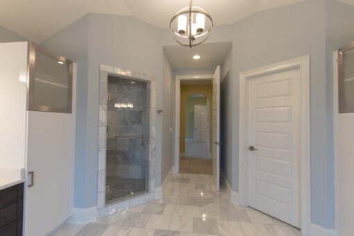 Ravenna primary bath with glass shower and marble floor