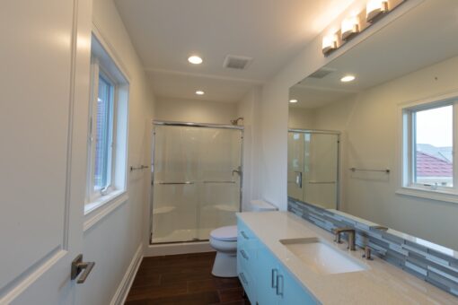 Ravenna bathroom with glass shower and blue vanity