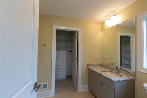 Ravenna bathroom with gray vanity and walk-in closet