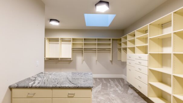 Davidson primary closet with granite island and skylight
