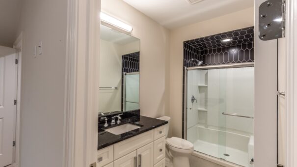 Davidson bathroom with black granite vanity and glass shower