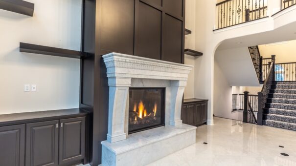 Davidson great room cast stone fireplace and dark built-ins