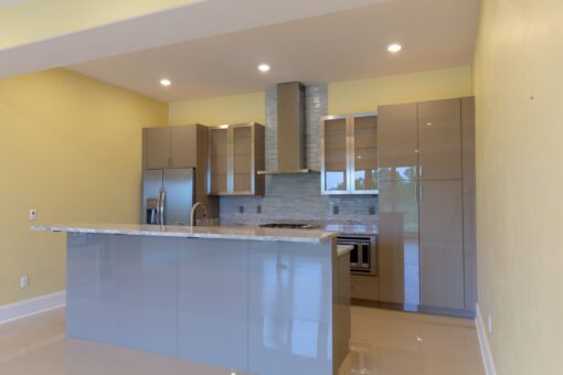 Ravenna lower-level kitchen with gray cabinetry and stainless hood