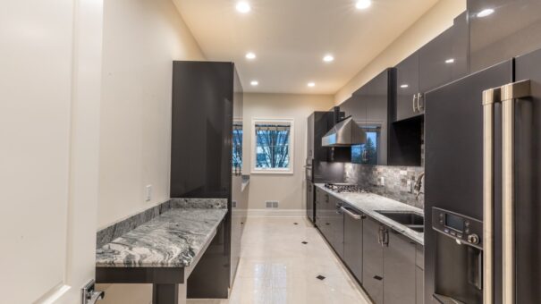 Davidson butler's pantry with dark cabinetry and granite