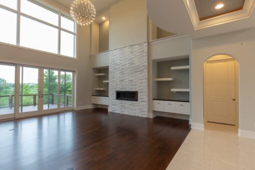 Ravenna great room with stacked stone fireplace wall and built-in shelves