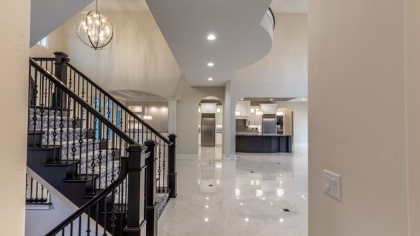 Davidson foyer staircase with iron railing and view to the kitchen