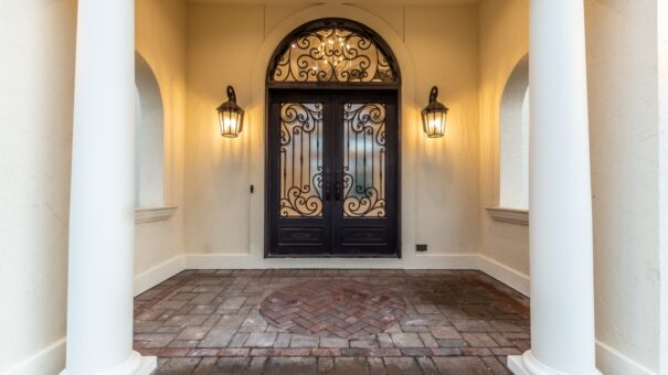 Davidson arched iron entry doors with lanterns and brick pavers