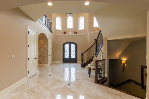 Summerhill foyer with arched entry doors and staircase
