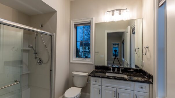 Davidson bathroom with white vanity and black granite