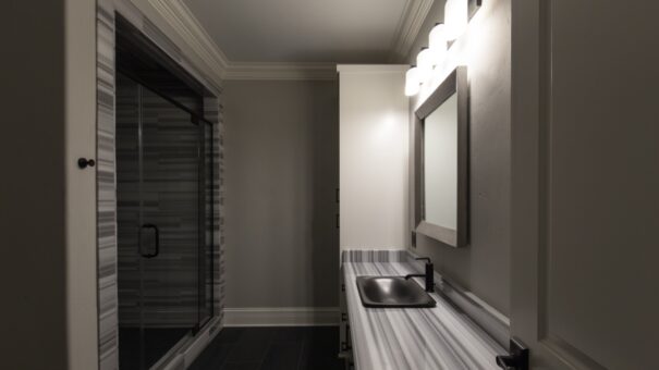 Bella Haven bathroom with glass shower and gray vanity