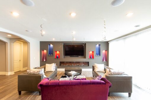 Summerhill lower-level family room with media wall and lit niches