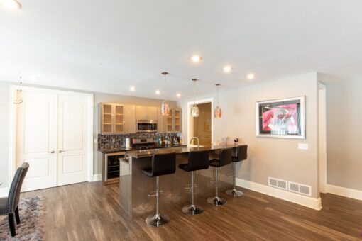 Summerhill lower-level bar with stools and pendant lights