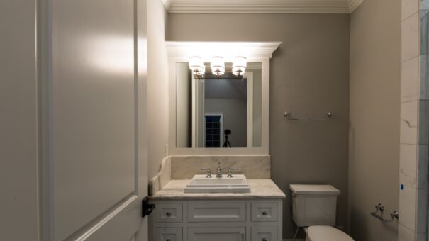 Bella Haven bathroom with white vanity and sconces