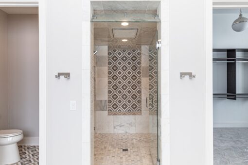 Birchwood walk-in shower with patterned tile accent