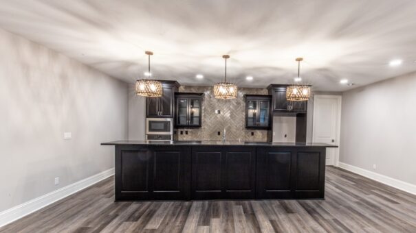 Davidson lower-level bar with dark island and pendant lights