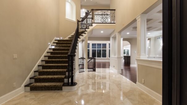 Bella Haven foyer staircase with carpet runner and iron railing
