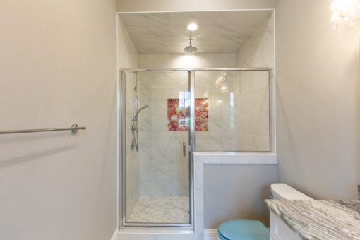 Shire glass shower with marble tile