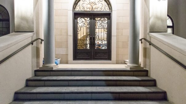 Bella Haven stone entry steps and arched iron double doors