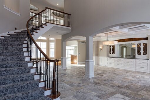 Birchwood foyer curved staircase with iron balusters