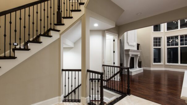 Bella Haven staircase with iron balusters and view to the great room