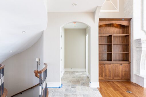Birchwood foyer with arched doorway and built-in cabinetry