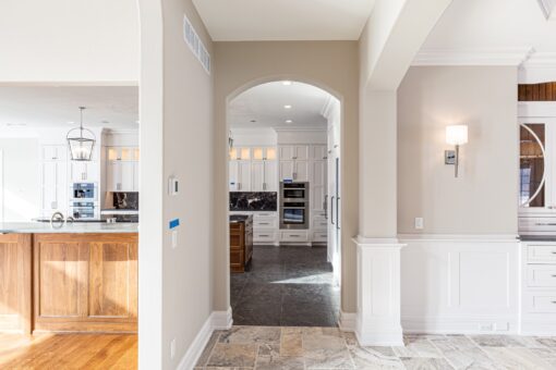 Birchwood foyer with arched opening to the kitchen