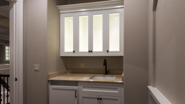 Bella Haven primary suite coffee bar with glass-front cabinets
