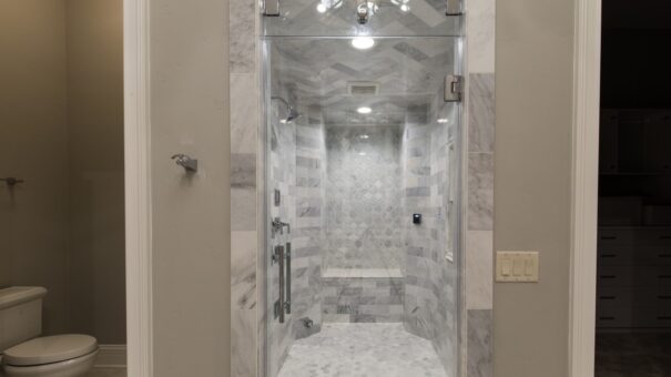 Bella Haven marble shower with glass door and chandelier