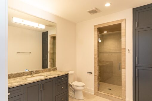 Birchwood bathroom with gray vanity and glass shower