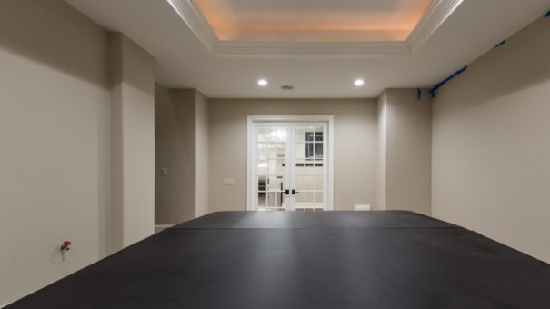 Bella Haven lower-level room with French doors and tray ceiling