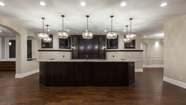 Bella Haven lower-level bar with dark island and pendant lights