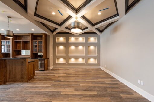Birchwood lower level with lit built-in niches and coffered ceiling