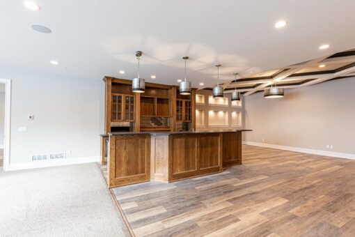 Birchwood lower-level bar with wood cabinetry and pendant lights