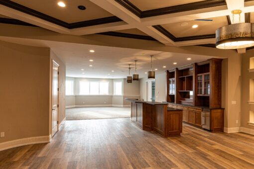 Birchwood lower level with coffered ceiling and wood built-ins