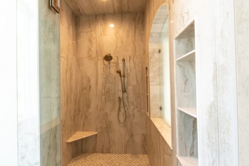 Shire walk-in shower with stone-look tile and bench