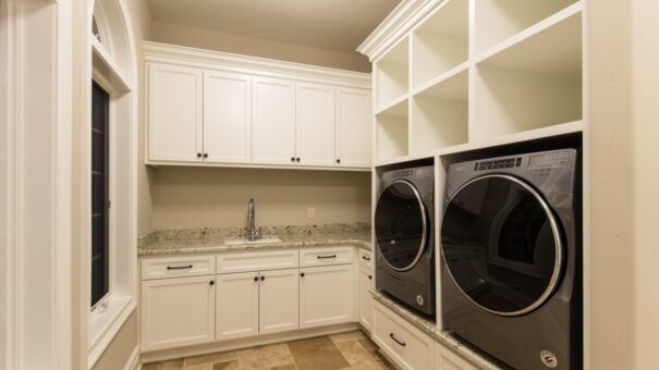 Bella Haven laundry room with front-load machines and cabinetry