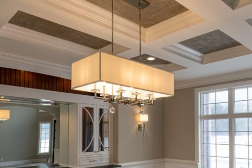 Birchwood rectangular chandelier beneath a coffered ceiling