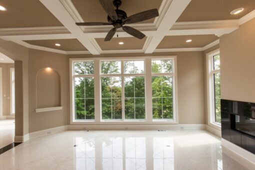 Shire hearth room with coffered ceiling and wall of windows