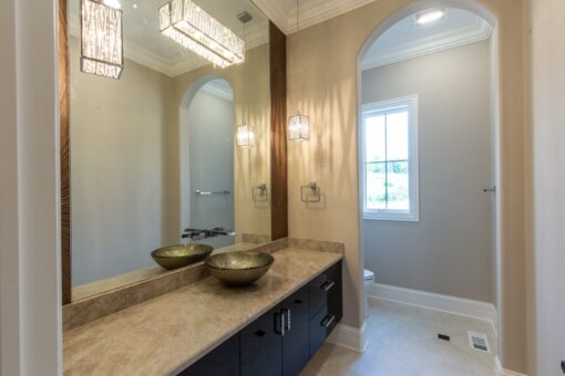 Shire bathroom with vessel sinks and dark vanity
