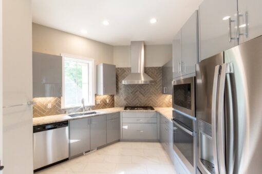 Shire kitchen with gray cabinetry and stainless appliances