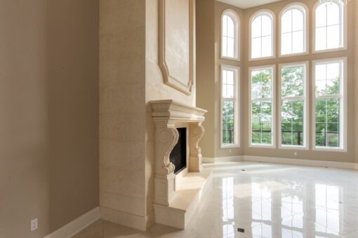 Shire great room with stone fireplace and arched windows